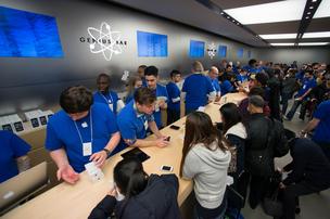 Employees ring up customers during the launch of the Apple's iPhone 5C and 5S at the company's store in New York on Friday.