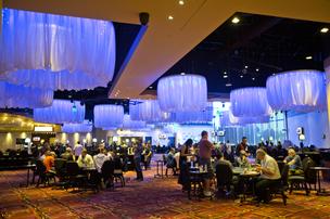 The card room:
The main floor of the casino room. Some 2,500 to 5,000 people come to the casino each day. Most of the crowd is from San Jose, although the casino brings in players from San Francisco and South Bay cities as well. Demographics lean male, ages 25 to 54, with slightly higher education and high ethnic diversity. The casino has especially reached out to the Asian demographics. Its name is one reflection of that strategy, as eight is considered a lucky number in many Asian cultures).
Games include: Texas Hold’em, Blackjack, Baccarat, Double Hand Poker, Omaha Hi, Pai Gow Tiles, No Limit Hold’em