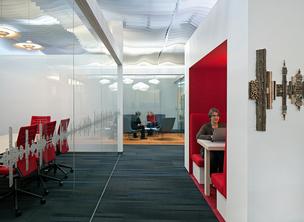 A photo inside the Gensler-designed Santa Cruz campus of Plantronics, which blends depersonalized open office space with semi-private booths, enclosed meeting space and conference rooms.