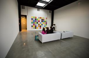 People watch as the colors from Spencer Finch's 