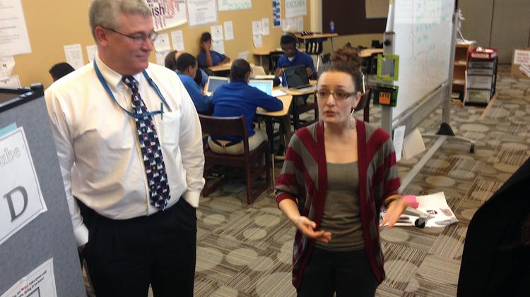 Hank Stopinski, principal of Health Sciences Charter school, and Nicole Carrol, a teacher, explain the school's new Center for Innovation digital lab.