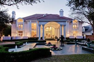 The evening light highlights the pink hue of the former Mary Kay Ash mansion in Dallas.