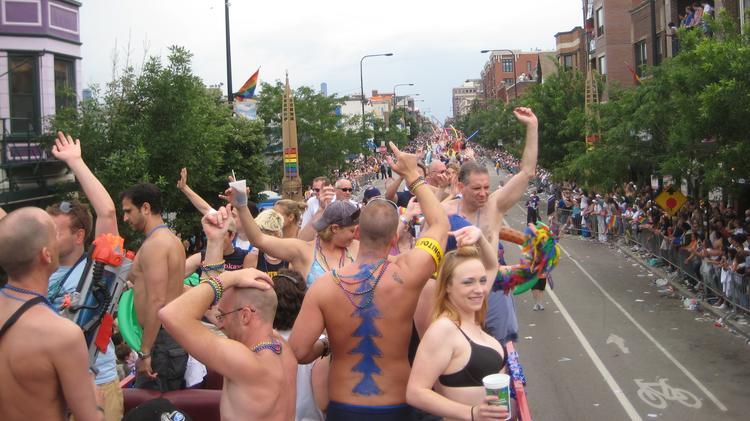 People wave from a float during the 2008 Pride Parade in Chicago. (Photo by Tony. Used under Creative Commons license.)