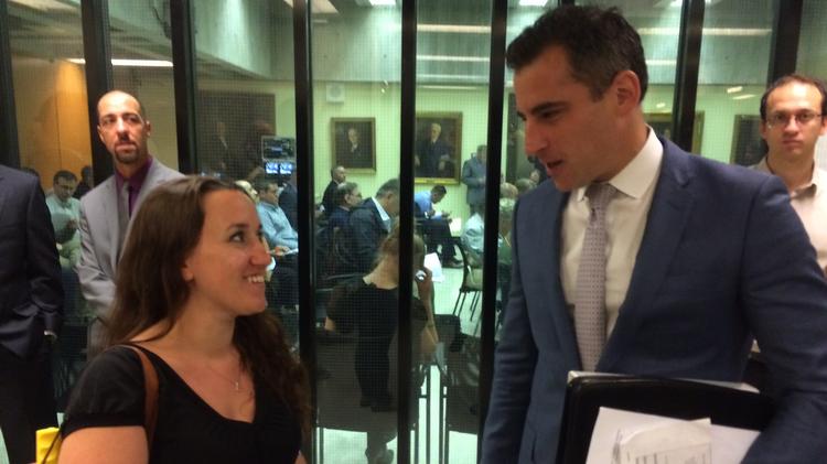 (from left) Nichole Snow, the executive director of the Massachusetts Patient Advocacy Alliance, speaks with Patriot Care Corp. attorney Michael Ross outside Tuesday's Zoning Board of Appeals hearing.