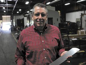 Cutting Edge: Chuck Biehn is CEO of CB Manufacturing, which posted more than $25 million in revenue last year, up 15 percent from the prior year. Biehn is holding a knife used by a food processor to cut chicken. 