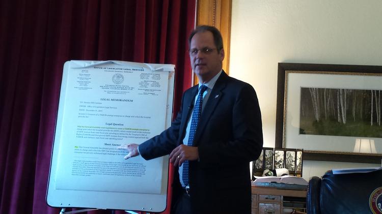 Colorado Senate President Bill Cadman points on Jan. 6, 2015 to an oversized copy of a memo he received from the Office of Legislative Legal Services arguing that the Legislature could not turn the hospital provider fee into an enterprise fund.