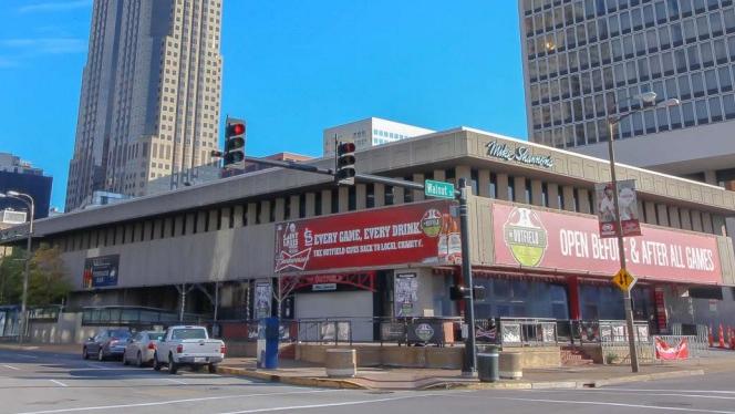 St. Louis Cardinals broadcaster Mike Shannon holds up a street