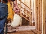 Construction Worker Closeup with Hardhat in Hand