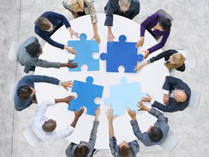 Business People and Jigsaw Puzzle Pieces