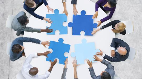 Business People and Jigsaw Puzzle Pieces