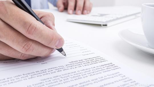 Businessman signing a document.