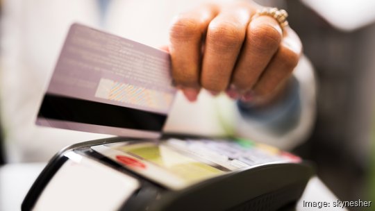 Close-up of credit card payment in pharmacy.