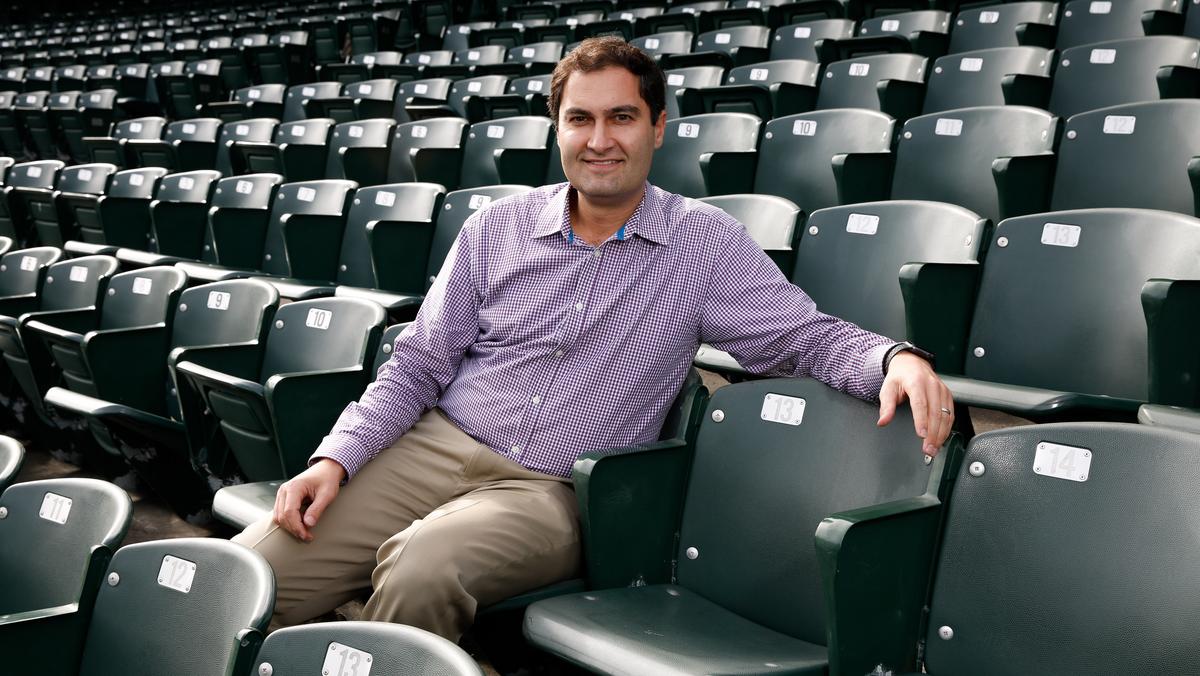 Oakland Athletics president Dave Kaval, left, talks with Reggie