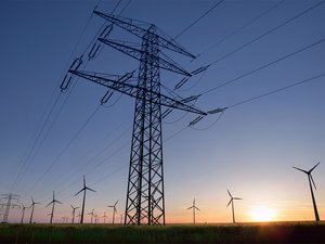 Overhead power line in front of wind turbines