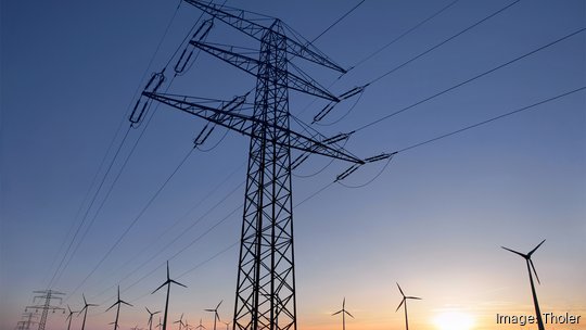 Overhead power line in front of wind turbines