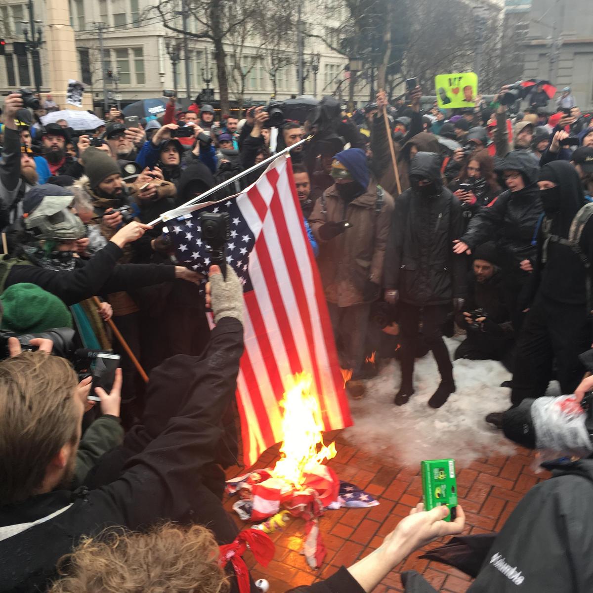 Amid boarded-up buildings and burning flags, protests start in downtown