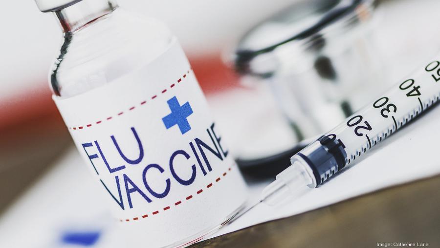 Flu vaccine with syringe and stethoscope