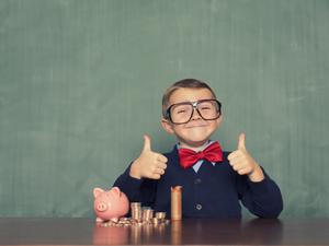 Young Boy Nerd Saves Money in His Piggy Bank