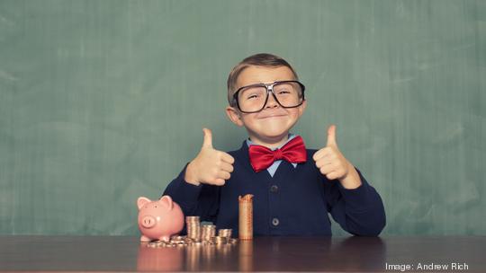 Young Boy Nerd Saves Money in His Piggy Bank