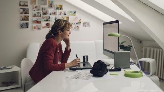 Photographer Editing Photos on her computer.