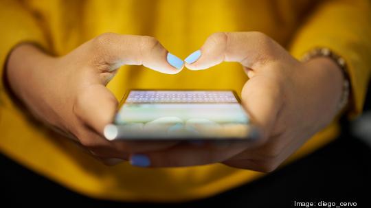 Woman Typing Phone Message On Social Network At Night