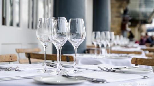 Empty table seen from side on terrace of restaurant