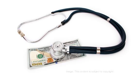 Stethoscope on money on white background - medical concept