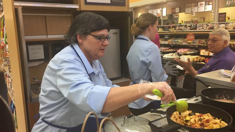 Publix employees dish up samples of the chicken bruschetta tortellini meal kit at the Southgate store.