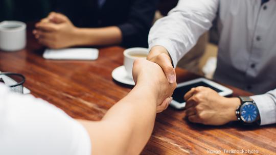 Close up of people shaking hands