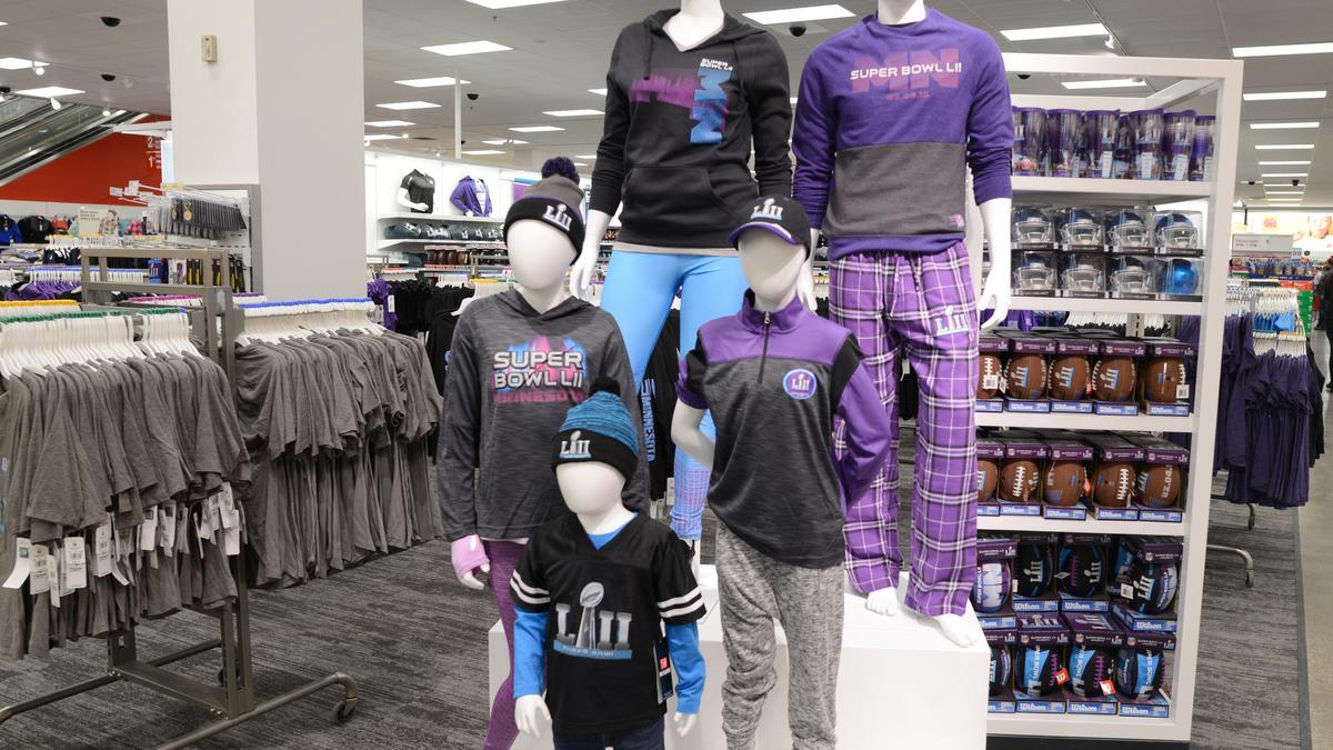 Fans shop at an official souvenir shop at Super Bowl Boulevard , a