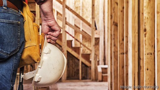 Construction Worker Closeup with Hardhat in Hand