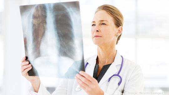 Female Doctor Examining X-Ray In Hospital