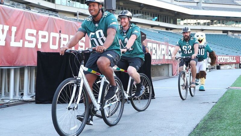 Hicks Wentz Kelce riding bikes at Sept. Presser preview