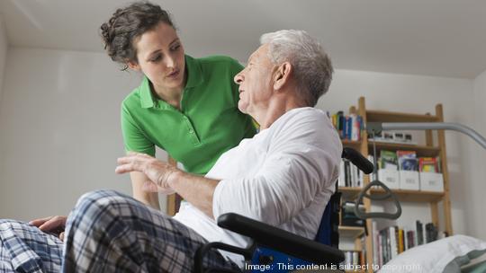 Germany, Leipzig, Man on wheelchair, talking with woman