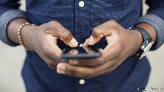 Midsection of man using mobile phone