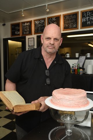 Keith Hand, owner of Hector’s Kitchen, with a strawberry cake, his ...