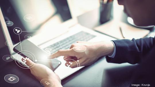 Businessman hand working with mobile phone and laptop computer  with technology digital graphic