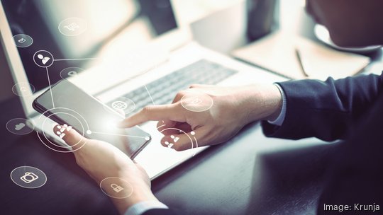 Businessman hand working with mobile phone and laptop computer  with technology digital graphic