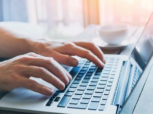 hands of business person working on computer