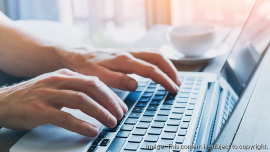 hands of business person working on computer