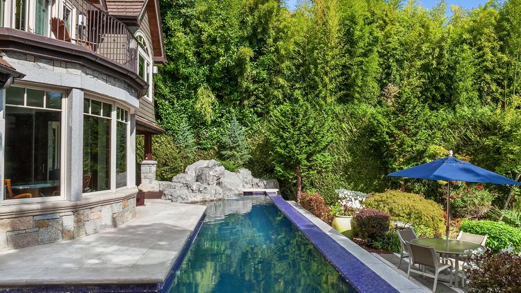 This Mercer Island home has an Infinity pool with underwater lights and an in-ground hot tub.