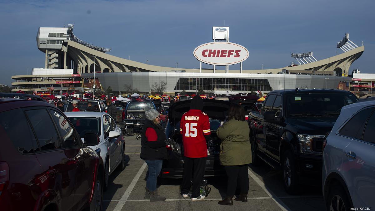 Cars are parked in a mostly empty parking lot at Arrowhead Stadium before  an NFL football game …