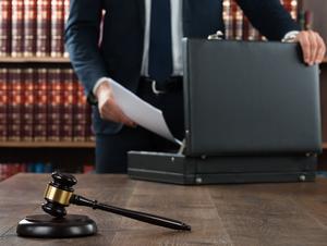 Lawyer Putting Documents In Briefcase