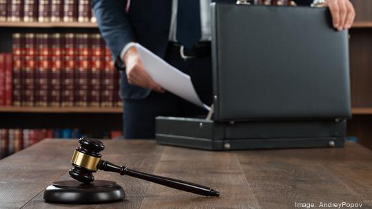 Lawyer Putting Documents In Briefcase