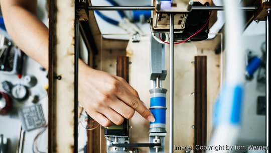 Engineering Student Setting Up 3D Printer