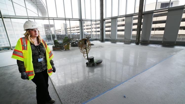Port of Seattle Aviation Project Management Group Capital Construction Project Manager Janet Sheerer stands near the new facilities of U.S. Border Patrol and Customs inside the future International Arrivals Facility, which is scheduled to open in the fall.