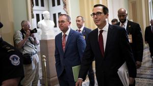 Mick Mulvaney, left, the acting White House chief of staff, and Treasury Secretary Steven Mnuchin head to a hearing of the House Financial Services Committee on Capitol Hill, in Washington, May 22, 2019. (Erin Schaff/The New York Times)