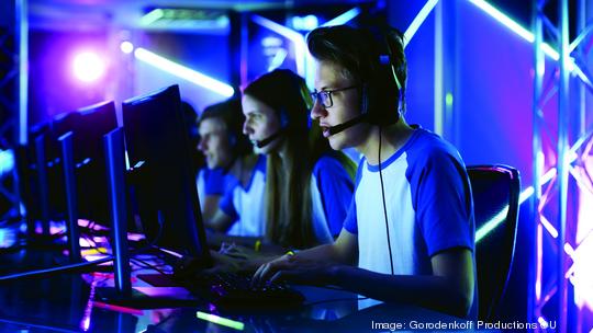 Team of Teenage Gamers Play in Multiplayer PC Video Game on a eSport Tournament. Captain Gives Commands into Microphone, Trying Strategically Win the Game.