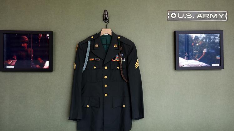 The uniform of Michael Lynd hangs on a wall at Lynd Co. as it's displayed with other items from men that served with Lynd during the Vietnam War.