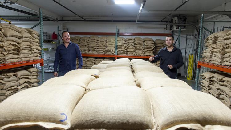 Hemp Depot co-founders Andy Rodosevich and Luke Pickering walk past hemp CBD seeds valued at $7,500 per bag. The room contains about 55,000 seeds and $16.5M in current inventory.